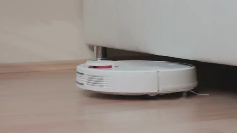 Automatic robot vacuum cleaner gets in and out under the raised furniture Video stock 150115286