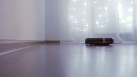 Automatic robot vacuum cleaner independently cleans the room Stock-Footage 121313457