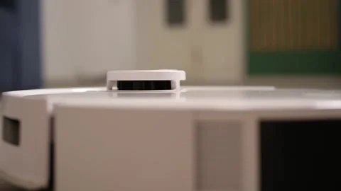 Automatic robot vacuum cleaner returning to its charging base after cleaning the Video stock 346318434