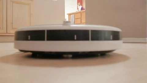 Automatic Robot Vacuum Cleaner Sweeps Hardwood Floor Stock Footage 80408726