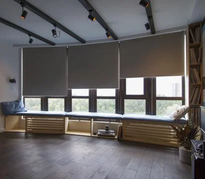 Automatic roller blinds beige color on big glass windows. Foto stock