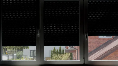 Automatic roller shutters opening on residential window indoors Stock Footage 334672885