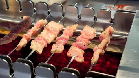 Automatic Rotating Skewers Grilling Meat on Hot Charcoal Grill Stockbeeldmateriaal 346905839