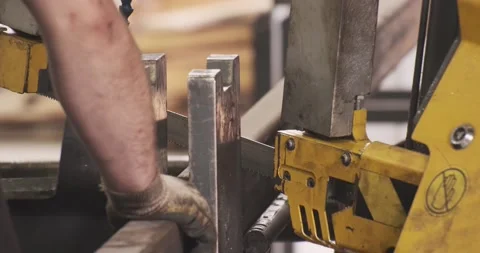 Automatic sawing machine cutting tool raw metal part on industrial band saw Video stock 188560723
