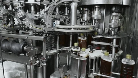 Automatic screwing of caps on plastic bottles. Stock Footage 288411422