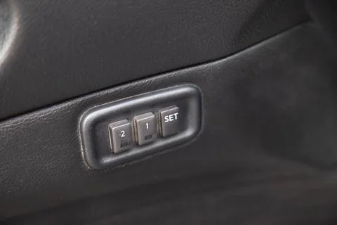 Automatic seat memory buttons with white signs and symbols are located in a.. Stock Photos