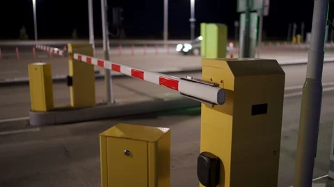 Automatic security system parking boom barrier car park system gate at night Stock Footage 125241657