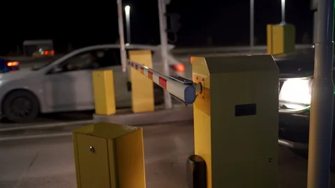 Automatic security system parking boom barrier car park system gate at night Stock Footage 126223436