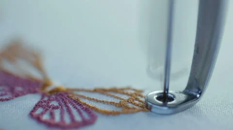 Automatic sewing machine embroiders the butterfly on a white cloth Stock Footage 60131646