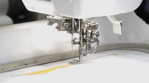 An automatic sewing machine embroiders a pattern Stock Footage 128732096