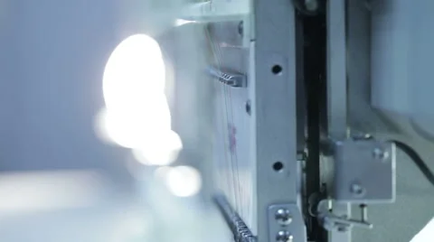Automatic sewing machine embroiders on white cloth Stock Footage 60131629