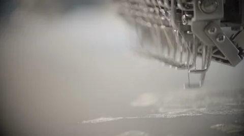 Automatic sewing machine embroiders on white cloth in slow motion Stock Footage 60131778