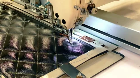 Automatic sewing machine is on stitching to make pattern on the black Stock Footage 254187269