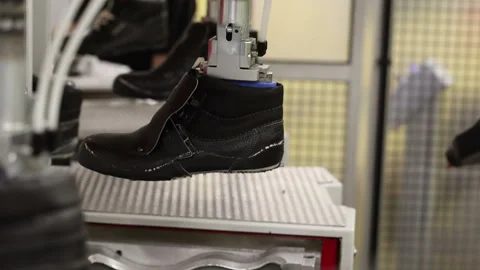 Automatic Shoe making machine close-up preparation for gluing the sole Stock Footage 125896400