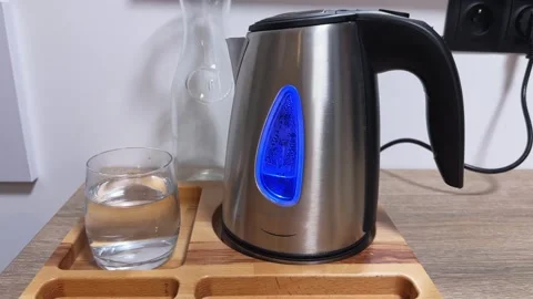 Automatic shutoff the stainless steel electric kettle after water boiling Stock Footage 342277098