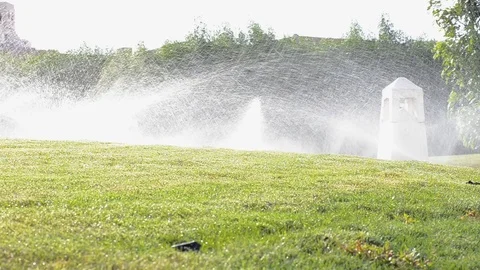 Automatic sprinkler system watering green grass lawn Video stock 95854743