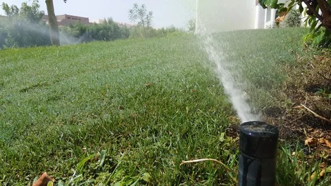 Automatic sprinkler system watering green grass lawn 動画素材 95856050
