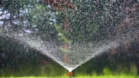 Automatic Sprinkler System Watering Green Lawn on a Sunny Day. Stock Footage 288576799