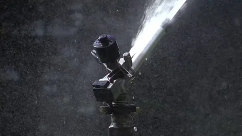 Automatic sprinkler under the sun Stock Footage 79754459