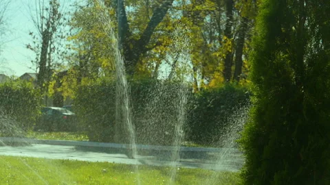 Automatic sprinkler watering system for plants and lawn. Slow motion. HD Stock Footage 88430778
