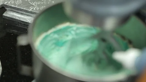 Automatic stand mixer blending blue dye for baking Stock Footage 106944974