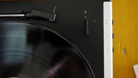 Automatic tonearm in vinyl record player starting to play Stock Footage 302492671