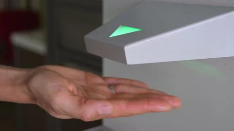 Automatic touchless hand sanitizer dispenser with antiseptic in use during COVID Stock Footage 138361450