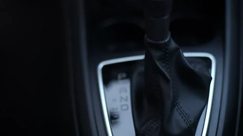 Automatic transmission in a modern car. Gearshift lever close up shot panning up 스톡 동영상 203978705