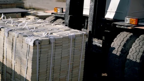 An automatic trolley is stacking pallets with bricks next to each other Stock Footage 97785782