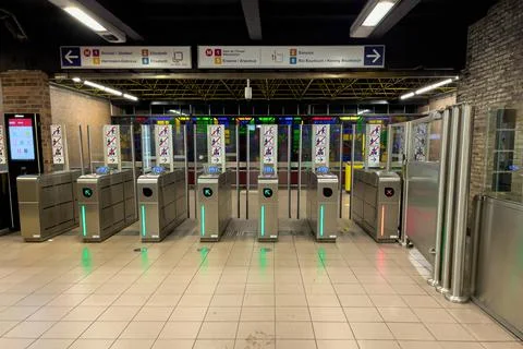 Automatic turnstiles inside subway station with signs of entry in Brussels Stock Photos