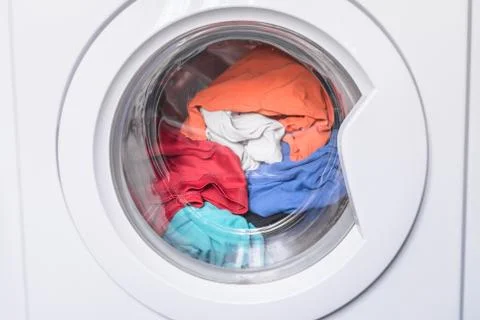 Automatic washer with open door. Erasing home t-shirts. Dirty clothes are ins Stock Photos