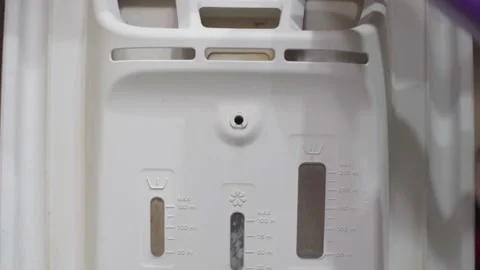 The automatic washing machine is filled with a liquid that softens the fabric Stock Footage 145717307