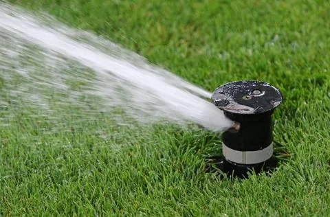 Automatic water irrigator in action Stock Photos