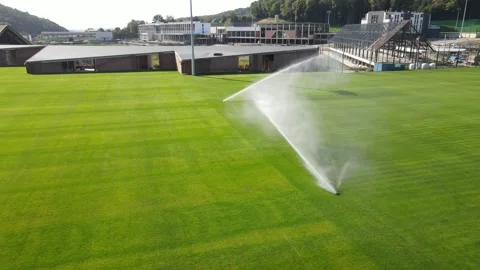 Automatic watering of the stadium and green grass. irrigation of green grass Video stock 138531523