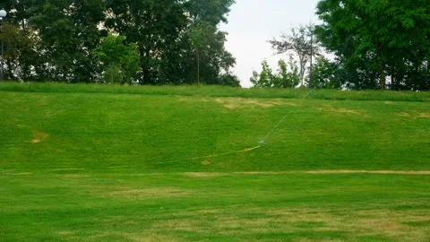 Automatic watering system for the green grass in the park Stock Footage 134230577