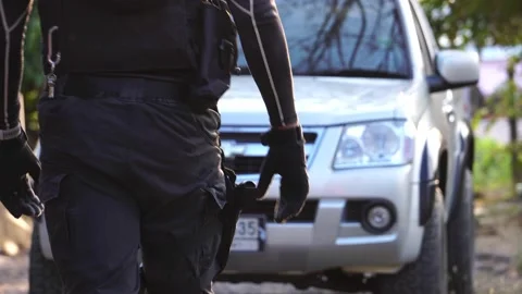 An automatic weapon in the hands of a man in uniform Stock Footage 233603707