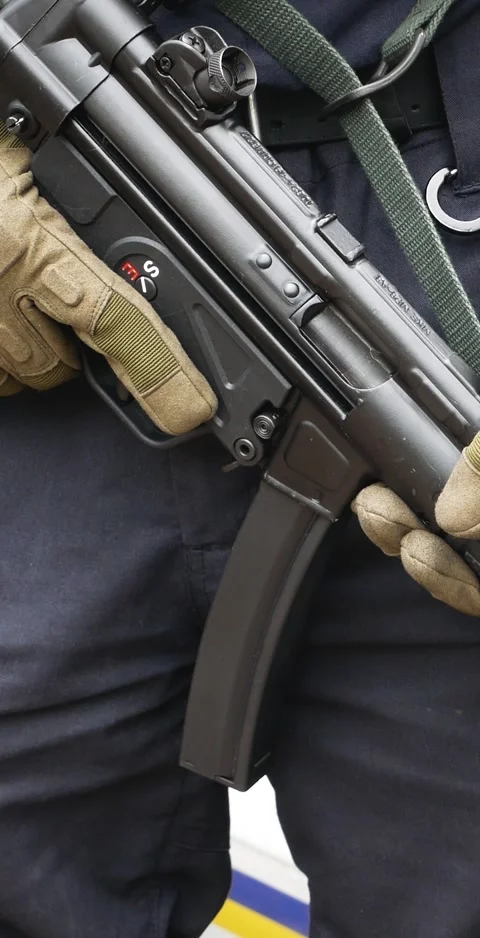 An automatic weapon in the hands of a man in uniform. Stock Footage 311309368