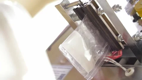 Automatic weighing and filling machine - seal transparent bag with white powder Stock-Footage 157233561