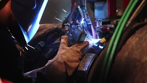 Automatic welding of large steel pipeline with sparks in factory close up Stock Footage 333380757