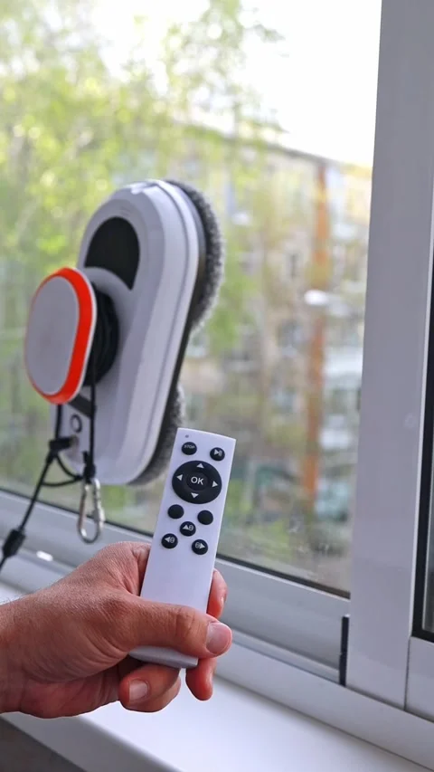 An automatic window cleaner programmed using a remote control is a device Stock Footage 276314938
