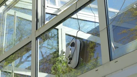 Automatic window cleaning robot cleans large glass surfaces of a modern veranda. Video stock 336842882