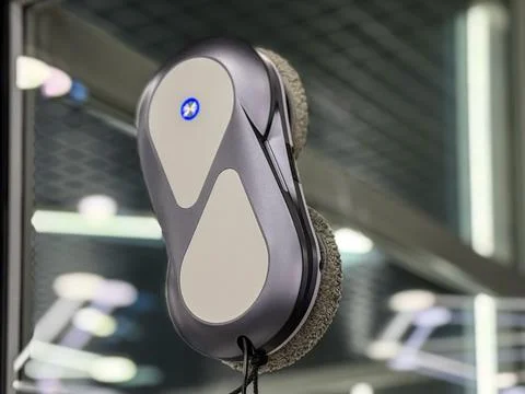 Automatic window cleaning robot washing glass. Stock Photos