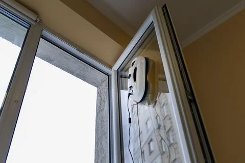 Automatic Window Cleaning Robot Working on an Open Glass Door Stock Photos
