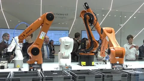 Automation solutions of the future with robot arms on Kuka stand on Messe fair Stock Footage 97789023
