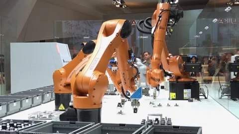 Automation solutions of the future with robot arms on Kuka stand on Messe fair Stock Footage 97789196