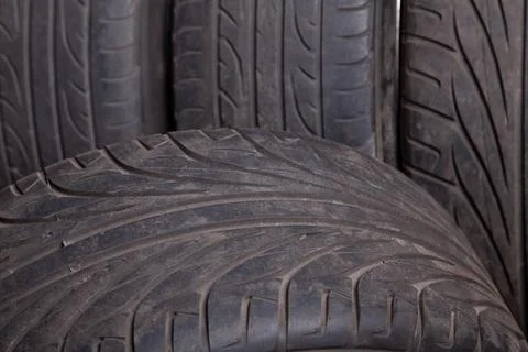 Automobile composition made up stack of tires and wheel with shiny disc in .. Stock Photos