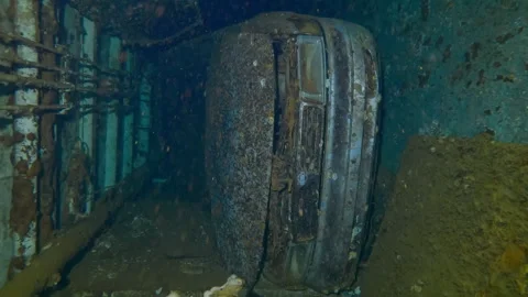 Automobile lying on its side inside hold of wreck Salem Express ferry Stock Footage 318038235