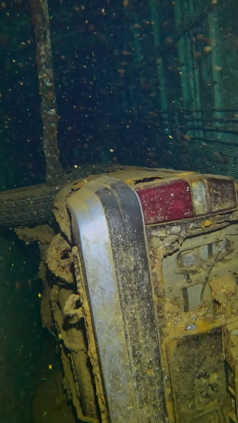 Automobile lying on its side inside hold of wreck Salem Express ferry, Close-up Stock Footage 328199500