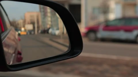 Automobile in motion. View in the rear view side mirror of a auto Stock Footage 311781437