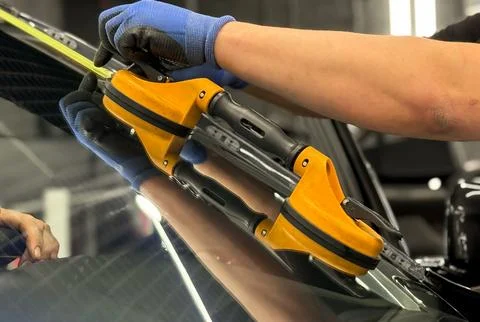 Automobile special workers replacing windscreen or windshield of a car. Stock Photos